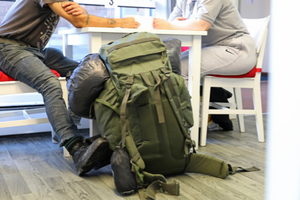 man with rucksack getting advice