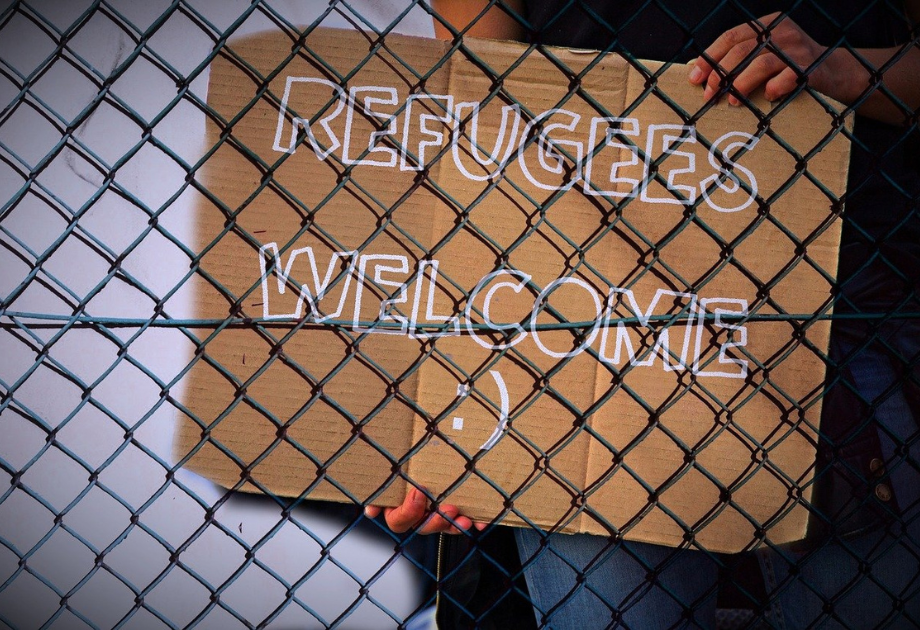 cardboard refugees welcome sign