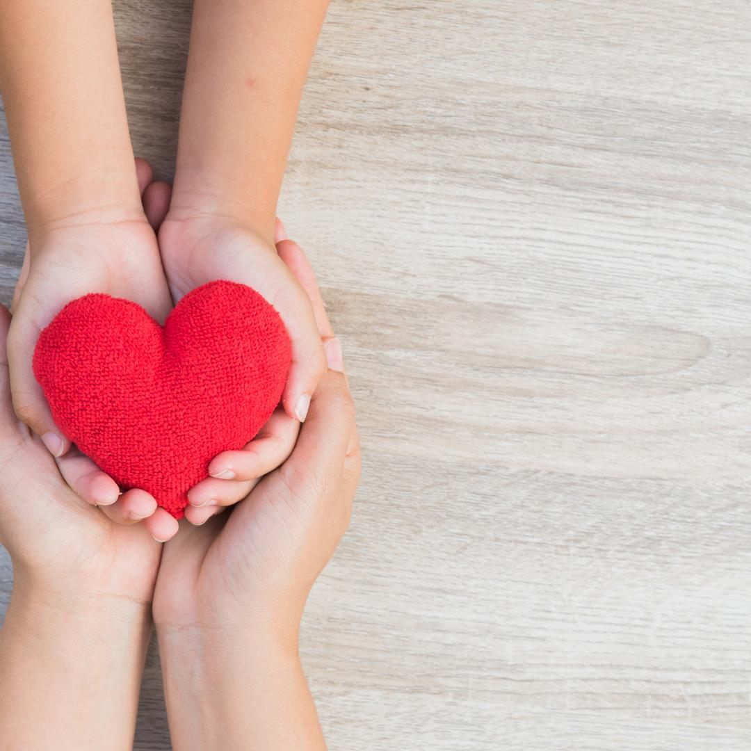 Image of hands holding a felt heart