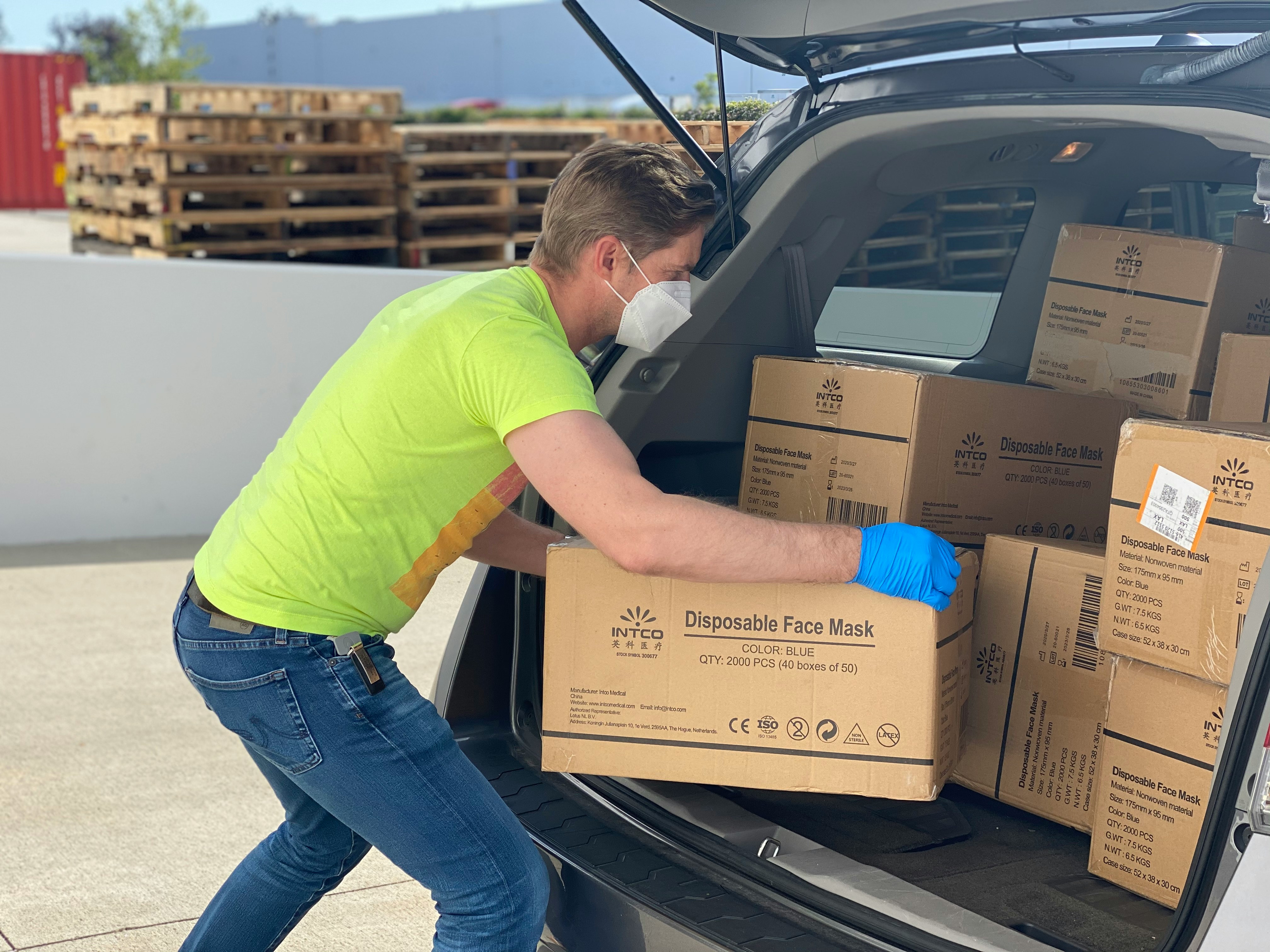 Image of man loading boxes into a car