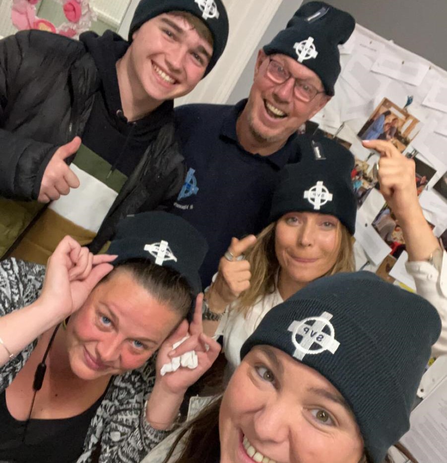 People posing wearing Newcastle Deaf Centre hats.