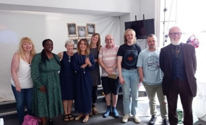 Group standing and smiling.