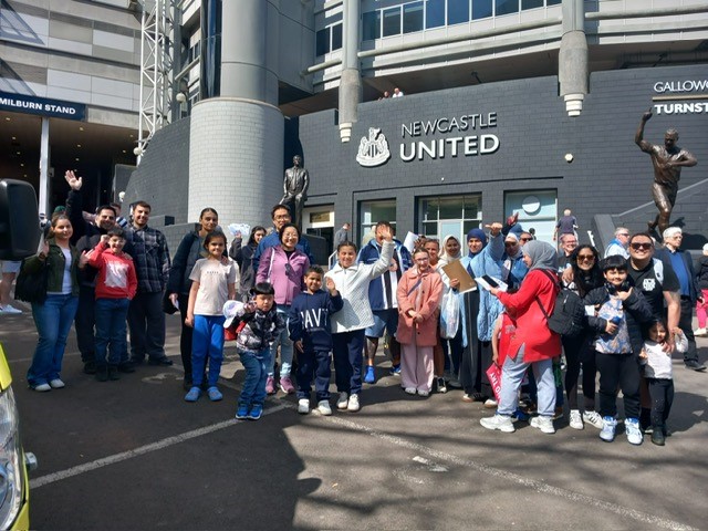 Kids outside of Newcastle United football stadium