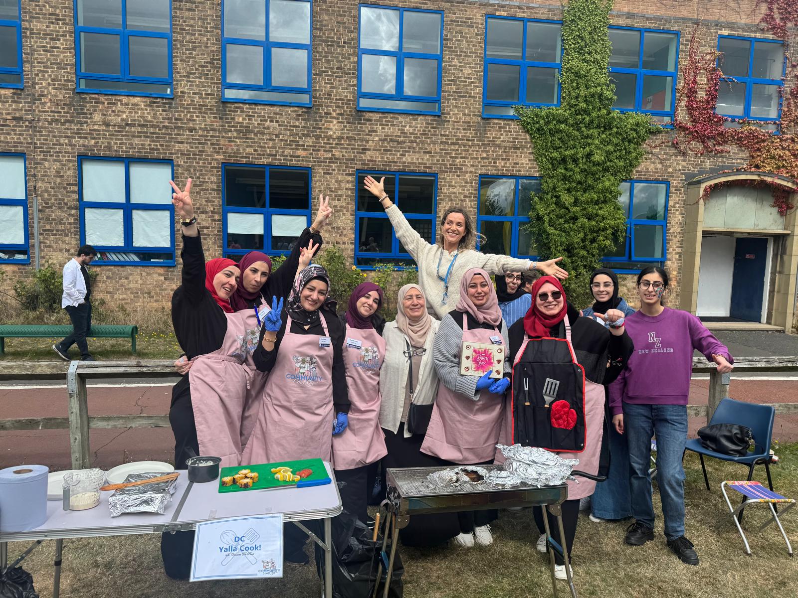 A group posing at a Yalla cooking stall.