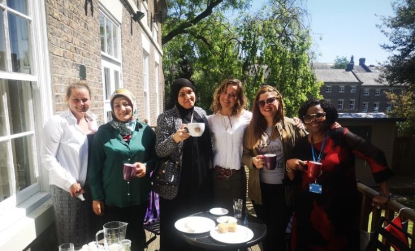 Head of centre (2024) with parents on a balcony.