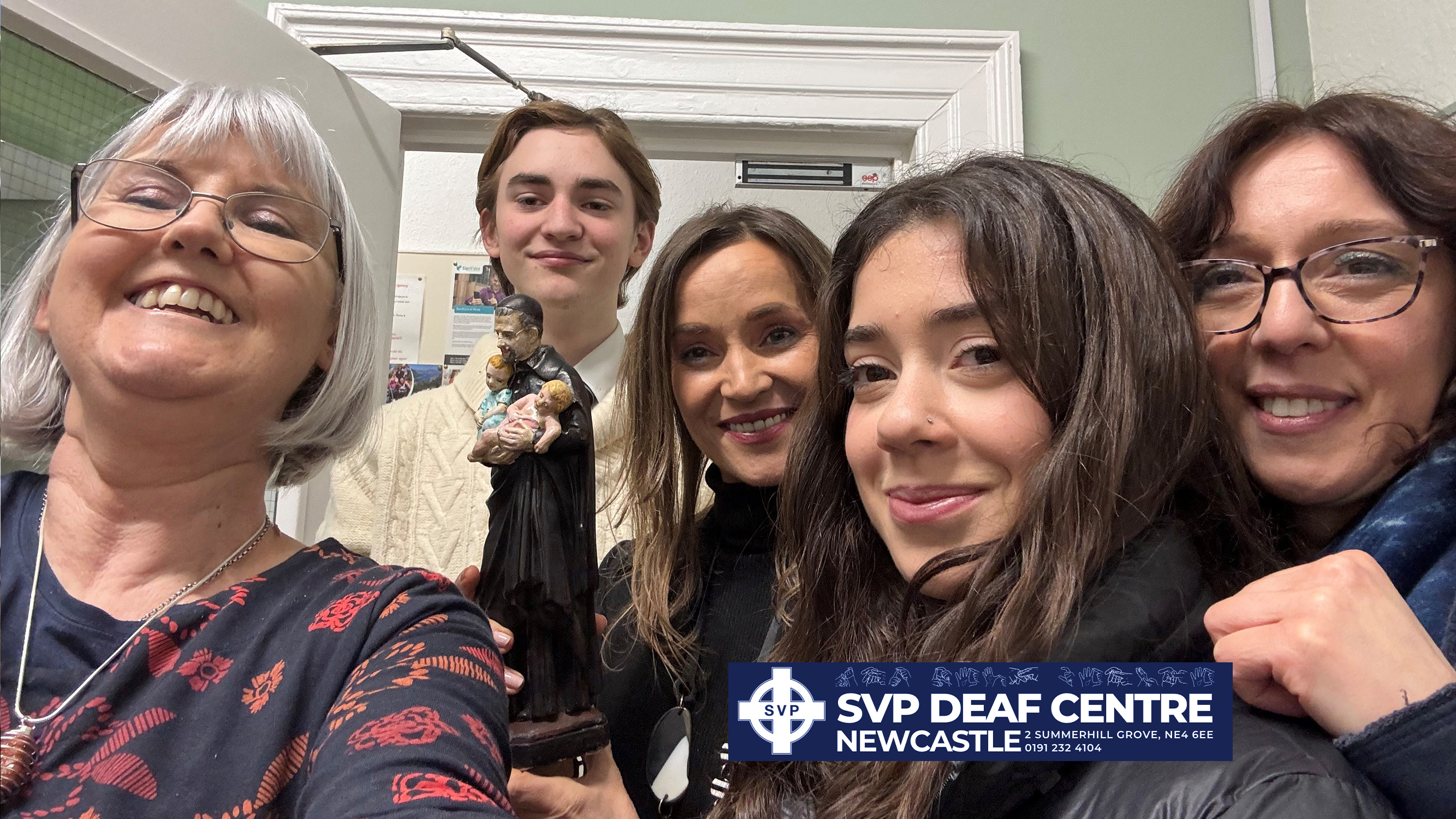 Deaf centre volunteers taking selfie.
