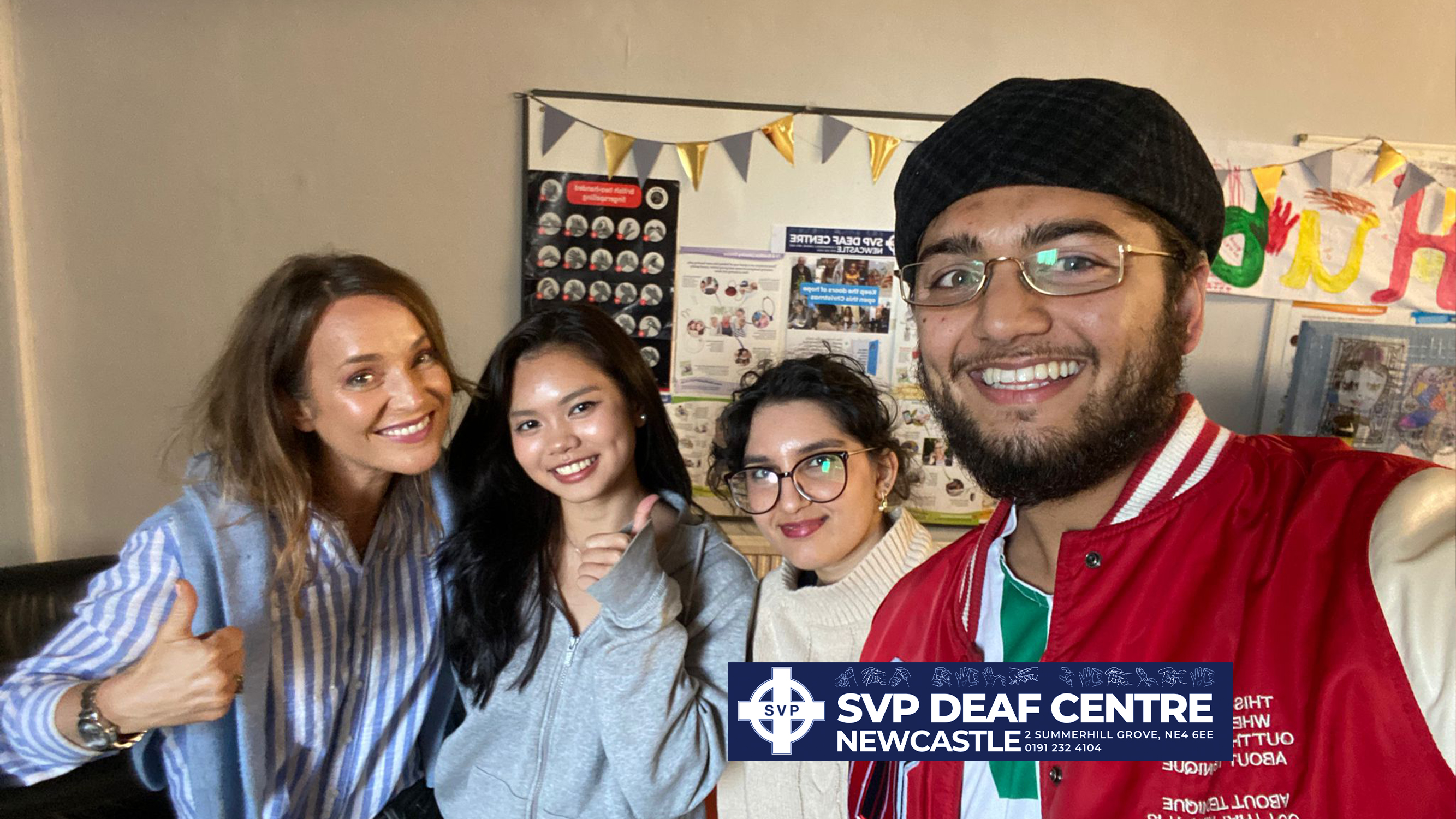 Group smiling taking selfie.