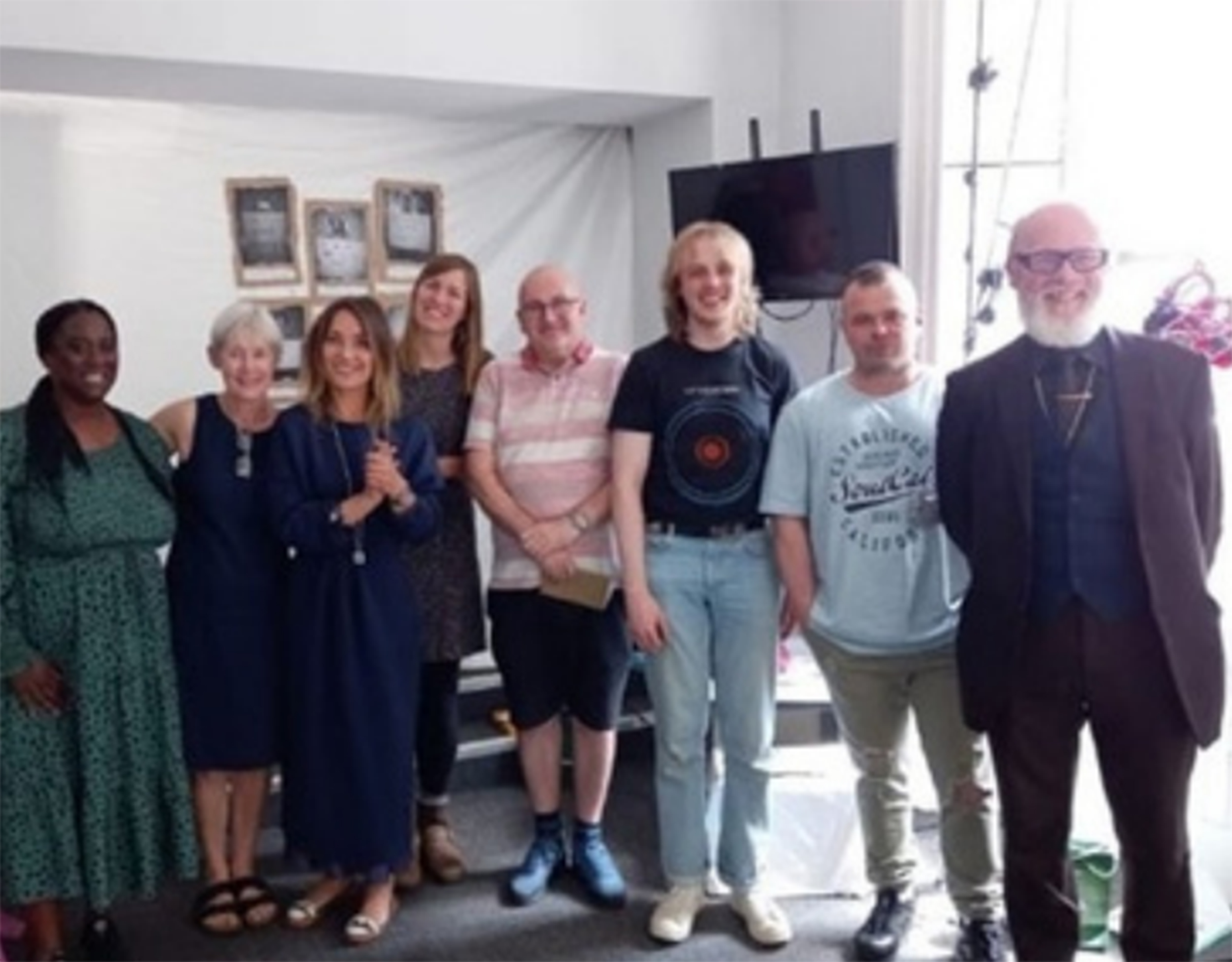 Group standing and smiling.