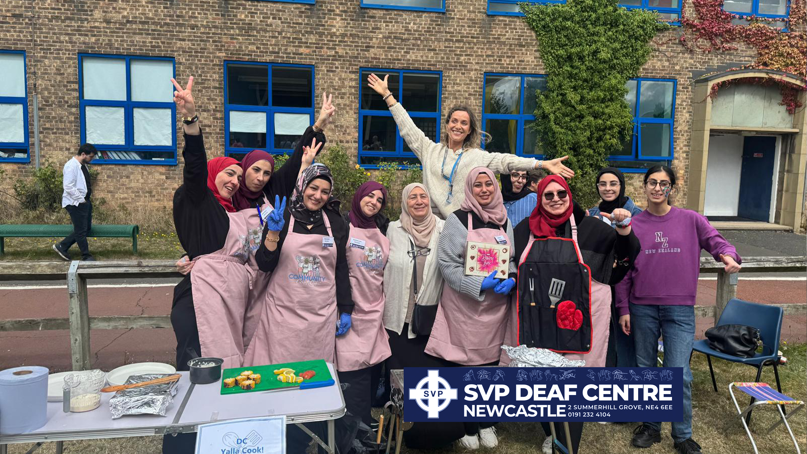 A group posing at a Yalla cooking stall.