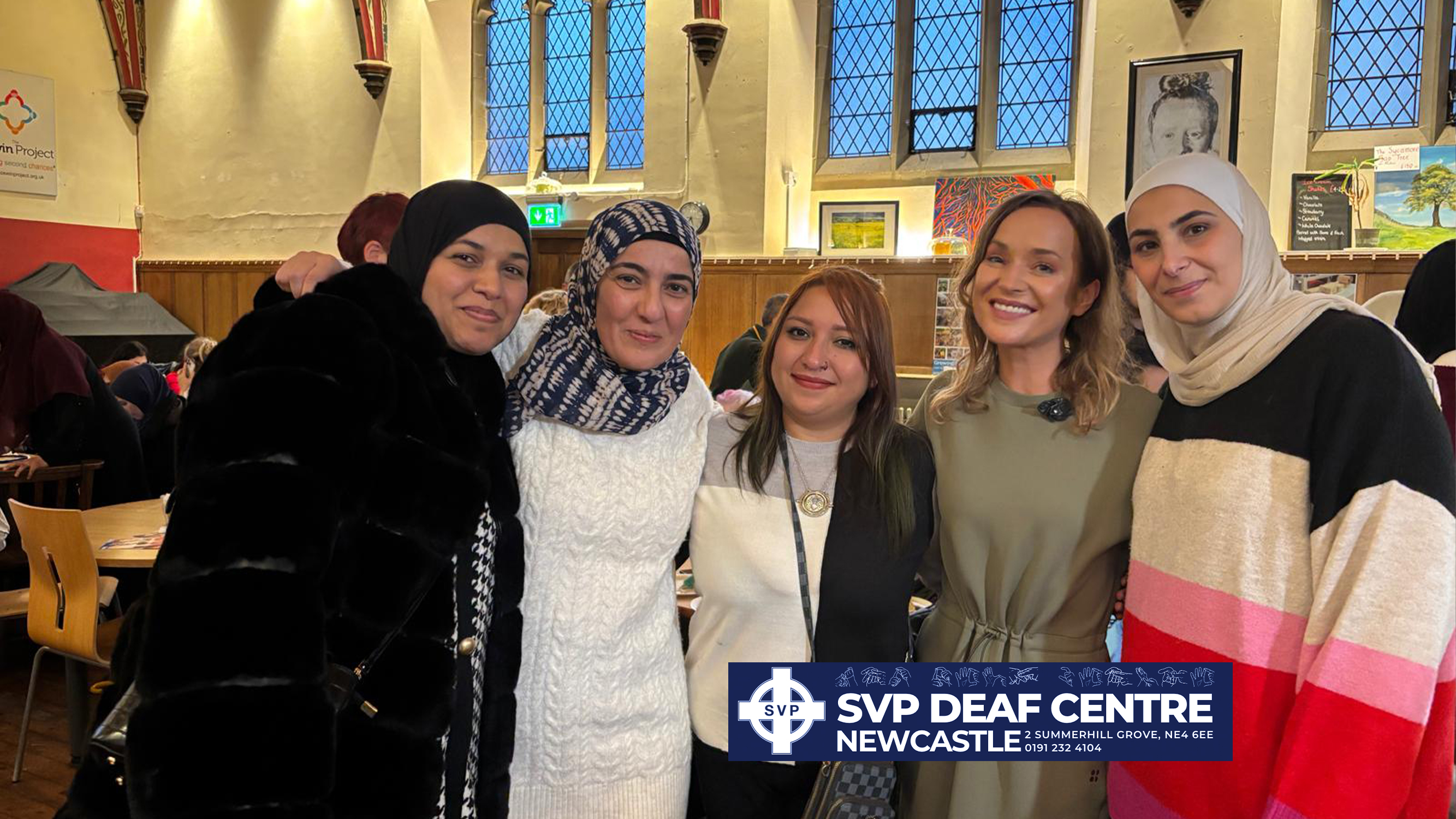 Women standing together smiling.