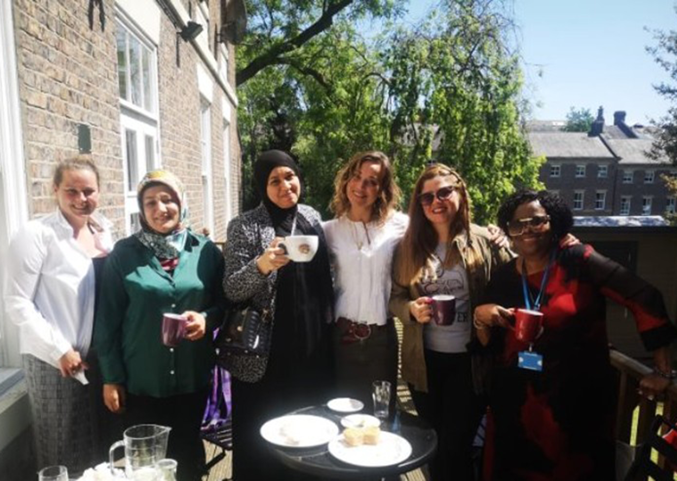 Head of centre (2024) with parents on a balcony.