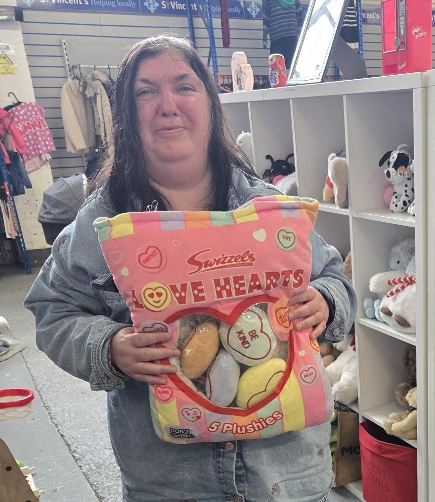 volunteer holding a bag of plushie hearts