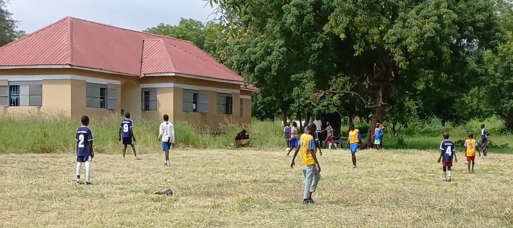 Boys playing football outside the home