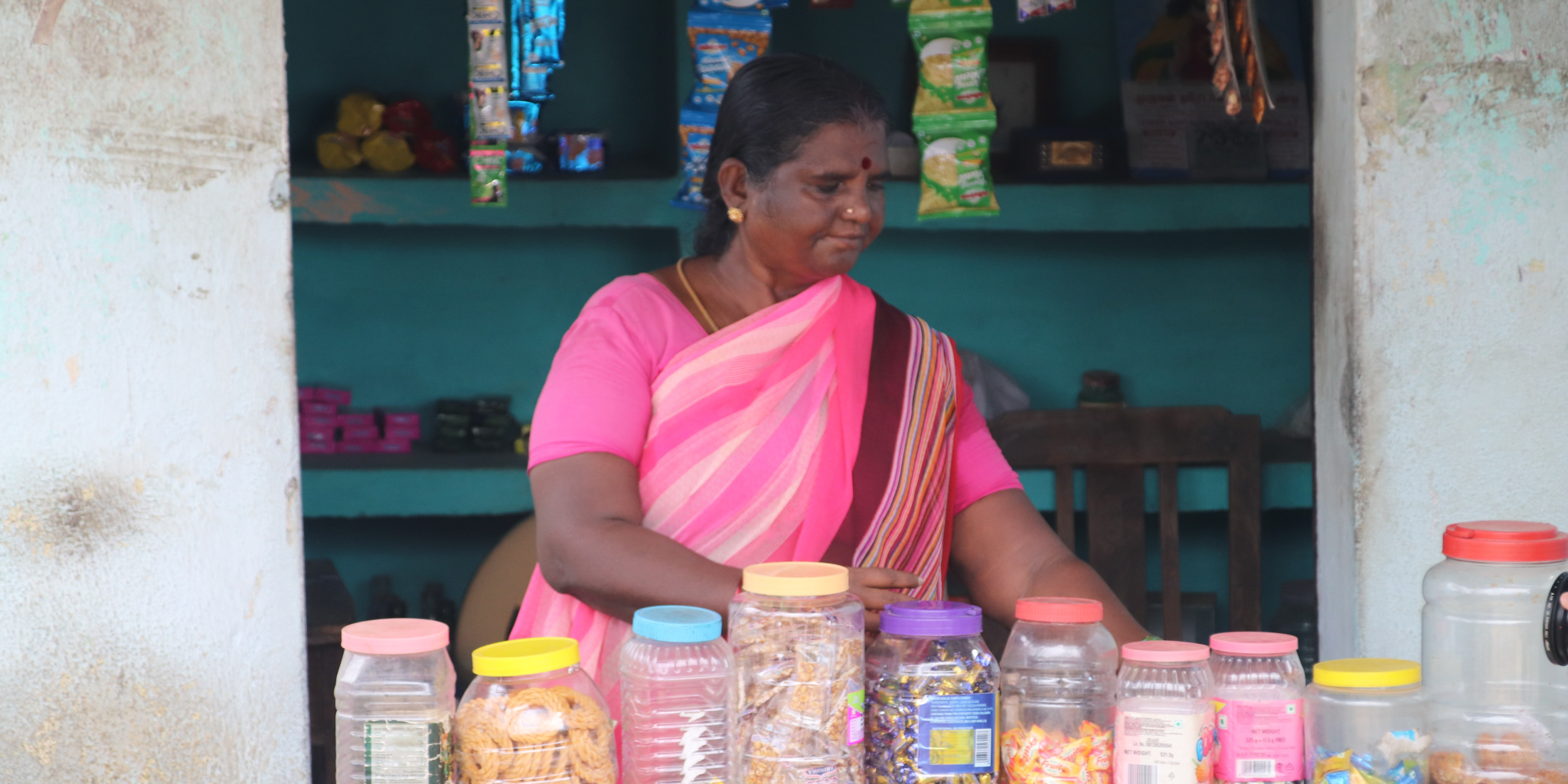 woman pink sari selling sweets