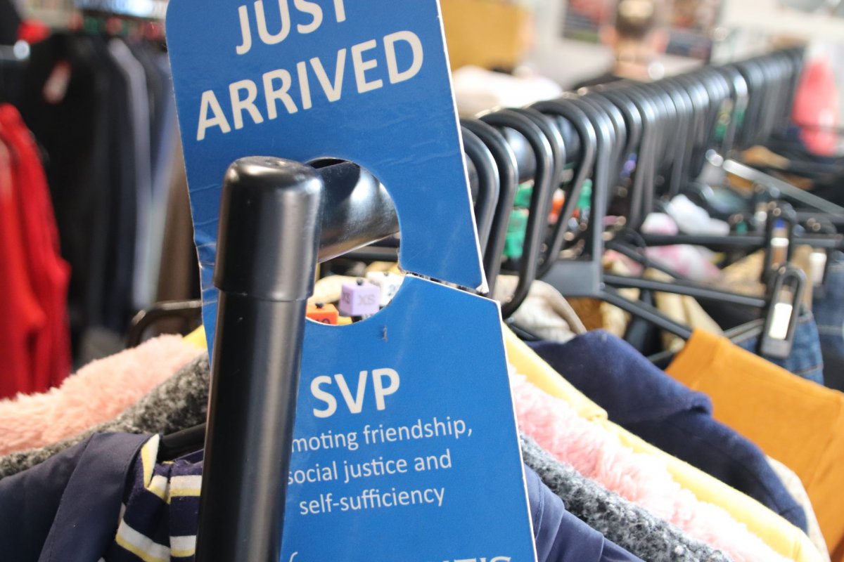 SVP shop clothing rack with blue just arrived sign