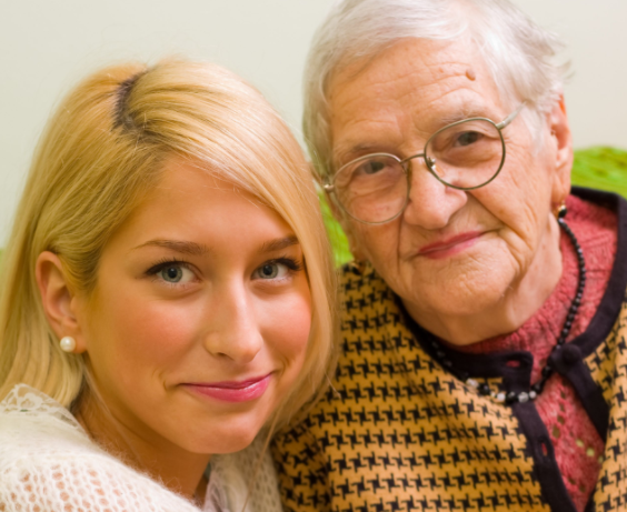 A younger and older lady looking directly into the camera