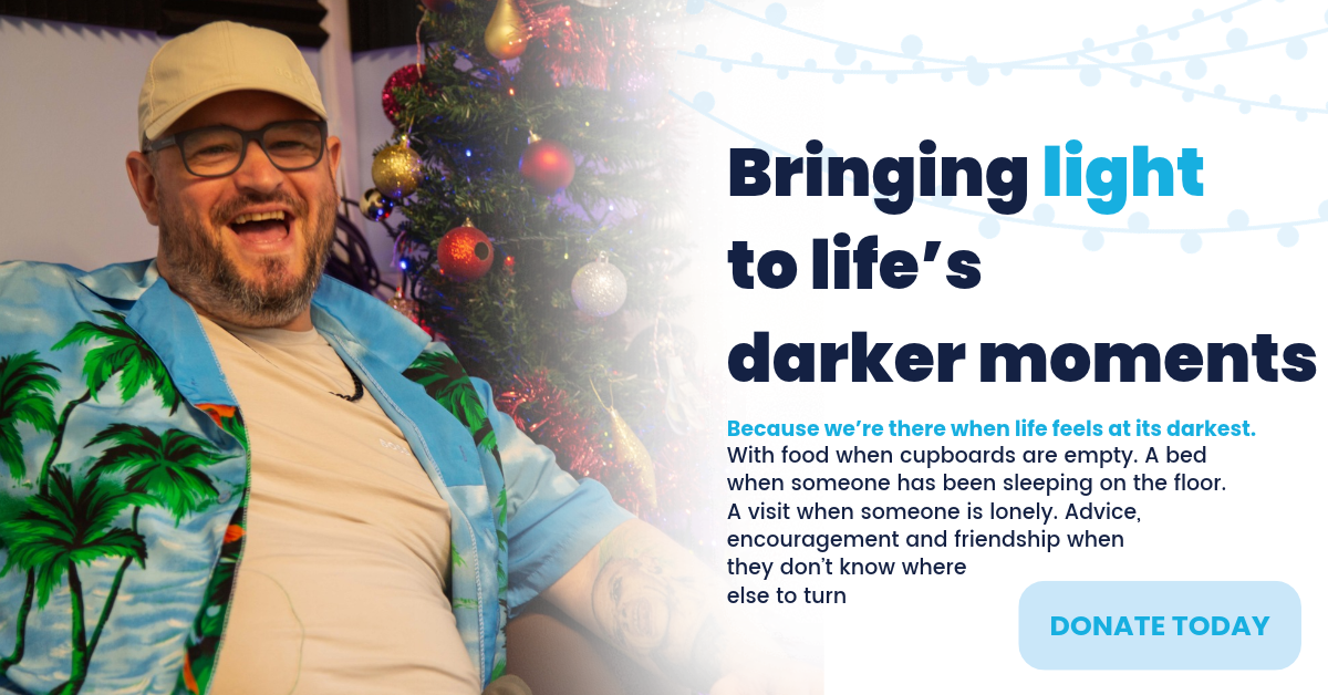 man smiling in front of xmas tree